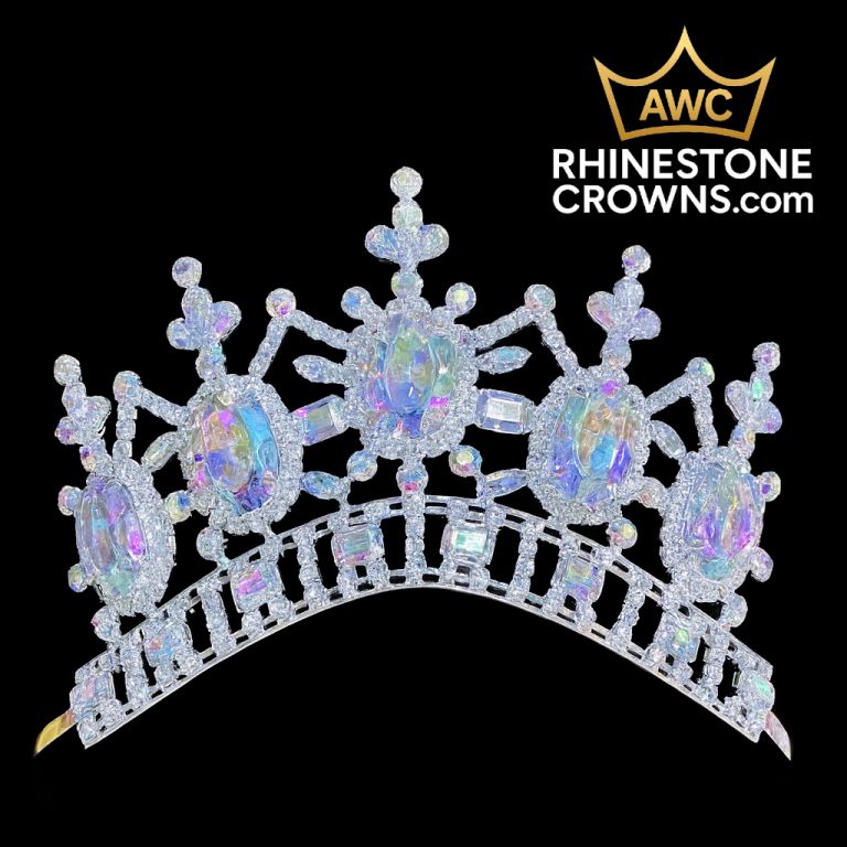 The Kimmy Series - 3.25" Tiara, a sparkling iridescent crown with oval and rectangular gems, is displayed against a black background. The top right features AWC RHINESTONE CROWNS.com and a gold crown logo.