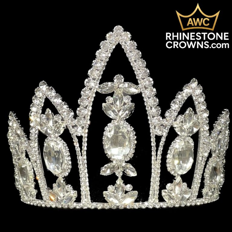 The Ballerina Series 6.25" is a sparkling silver rhinestone pageant crown with intricate, symmetrical patterns and large oval gems, shown on a black background with the RhinestoneCrowns.com logo in the upper right corner.
