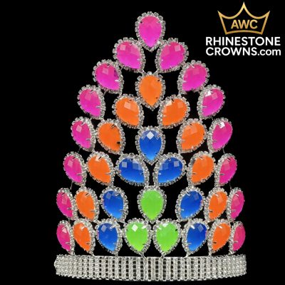 The Christmas Alessandra Series - 8.5" Crown features teardrop-shaped pink, orange, blue, and green rhinestones set in silver, shown on a black background with the AWC Rhinestone Crowns logo at the top right corner.