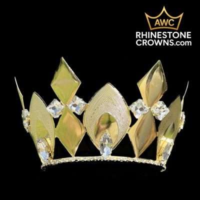 The Cruz Series-4"x 5"-Gold is a gold pageant crown with geometric diamond and leaf motifs, set with large clear gemstones. Alabama Wholesale Crowns’ golden crown logo appears in the top right, against a black background.