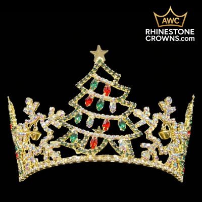 The Jingle All The Way Series-3"x5" Fully Round Crown sparkles with gold rhinestones, red and green accents, two gold bells, and a star atop. Ideal as a pageant or quince crown. AWC Rhinestone Crowns logo appears at the top right on a black background.