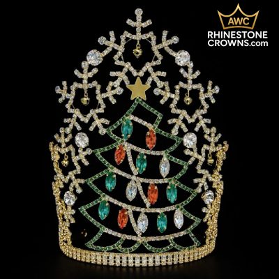 The Jingle All The Way Series-12" Crown features a gold rhinestone design with green, red, and clear gems shaped like a Christmas tree, topped with a gold star and snowflake patterns. Festive pageant crown. AWC RHINESTONE CROWNS.com logo appears in the top right corner.