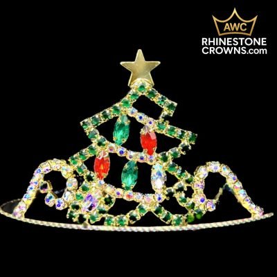 The Jingle All The Way Series-Economy 2" Tiara is a festive pageant crown shaped like a Christmas tree with green, red, and clear rhinestones, topped by a gold star and featuring the AWC Rhinestone Crowns logo in the top right corner.