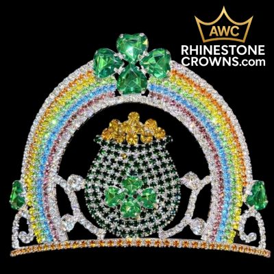 The Rainbow Treasure Series 4" crown features sparkling rhinestones, a rainbow, pot of gold, green shamrocks, and gems on a black background. “AWC RHINESTONECROWNS.com” is in the top right—ideal for any pageant.