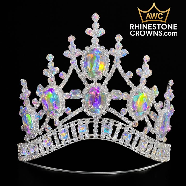 The Kimmy Series - 4" Crown features large iridescent gemstones and ornate rhinestone details—perfect for dance or pageants. Shown on a black background with the AWC Rhinestone Crowns logo in the upper right corner.