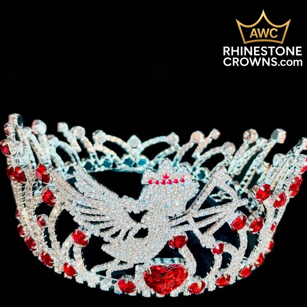 The Cupid's Bow Series - 3"x5" Round Crown features a winged angel design with red rhinestones and a heart, set against a black background. The AWC Rhinestone Crowns logo is in the top right corner.