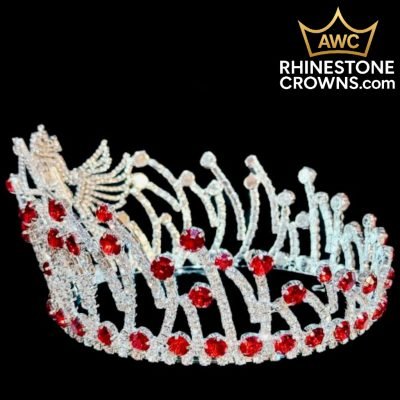 The Cupid's Bow Series - 3"x5" Round Crown features sparkling red and clear rhinestones in an intricate design with a decorative bird. The AWC RhinestoneCrowns.com logo appears at the top right on a black background.