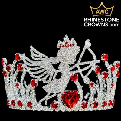 The Cupid's Bow Series - 3"x5" Round Crown features a sparkling rhinestone angel or cupid with a bow and crown, red gem accents, and a large heart-shaped jewel. Black background with AWC RhinestoneCrowns.com in the top right.