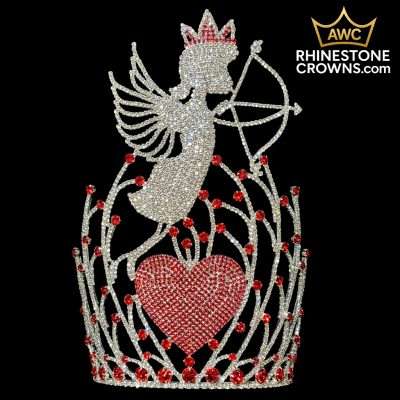 Front view of the Cupid's Bow 12" crown against a black background. A large, elaborate design features a sparkling silver rhinestone Cupid with wings and crown, holding a bow and arrow. Below is a large fully paved red rhinestone heart, surrounded by intricate branching vine-like designs accented with red rhinestones.